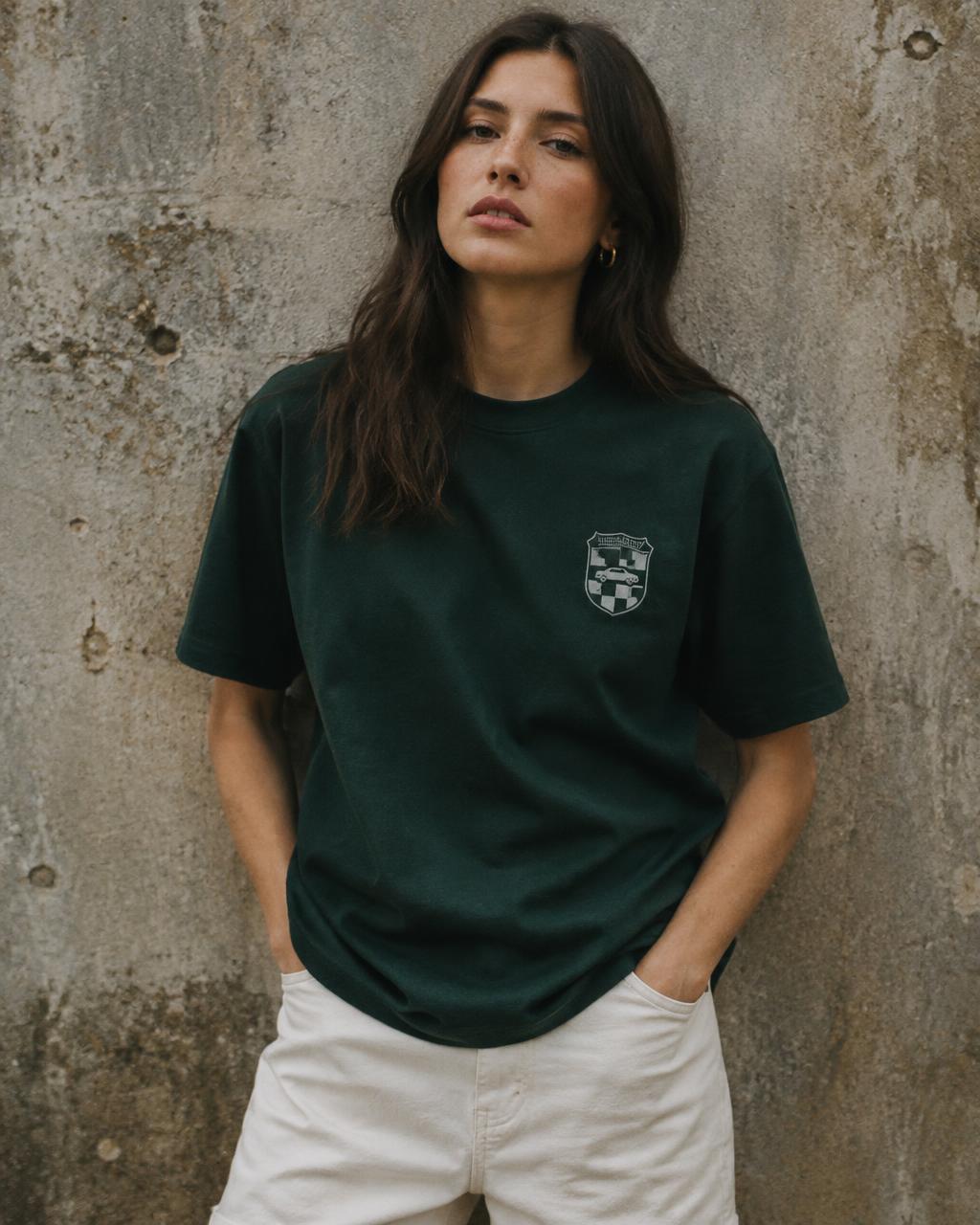 Model wearing a racing green Retro tee against a concrete wall